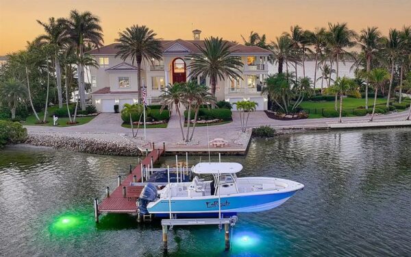 Waterfront Florida Gulf Coast home with private dock and yacht at sunset